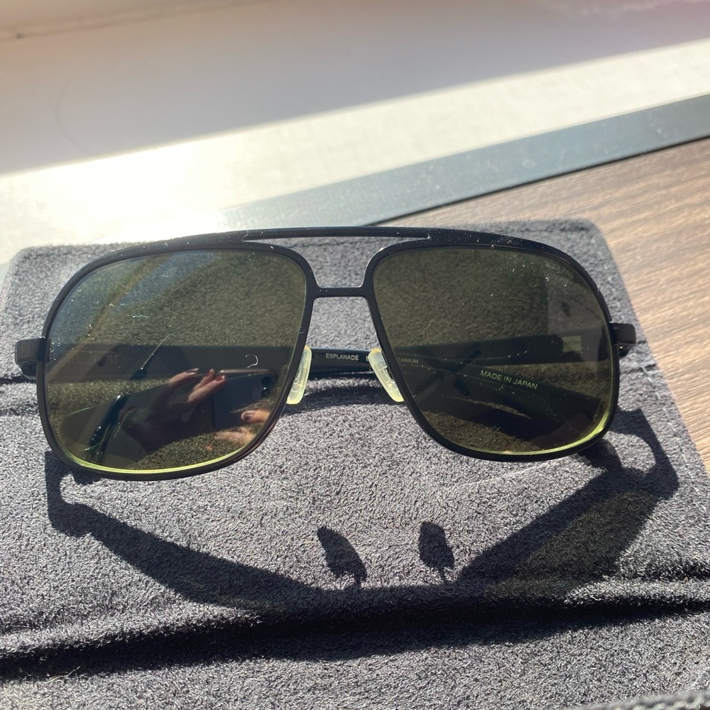 Men’s Tumi sunglasses with green tinted polarized lens